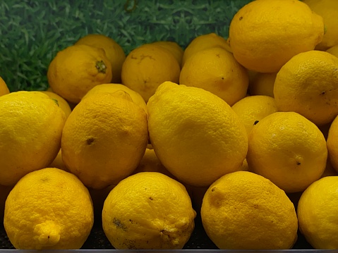 Towering pile of vibrant yellow lemons, a refreshing and zesty visual treat.