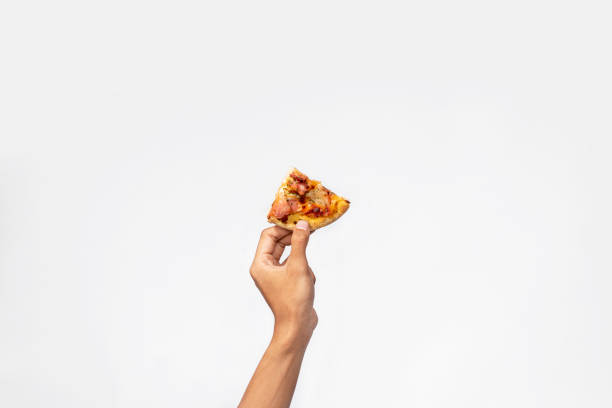 istock A human hand holding a slice of pizza 1701574754
