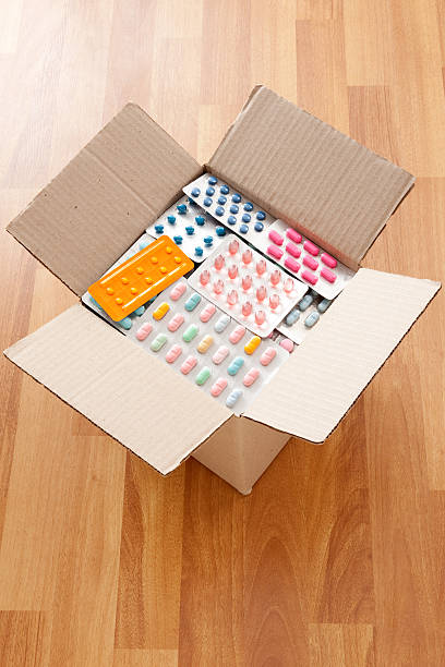 Boxed blister packs High angle view of cardboard box full of blister packs box of meds stock pictures, royalty-free photos & images