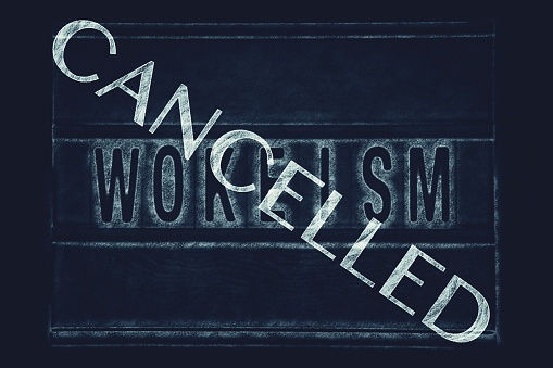 A chalkboard sign with the word Wokeism and a Cancelled Stamp ccross it for a Cancel Culture concept. This is part of my Signs of the Times Collection for Social History.