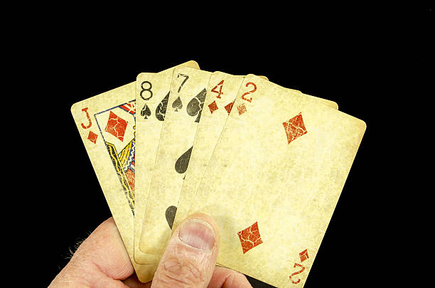 Hand of Poker Cards... Losing A poker hand of cards showing a losing and folding hand. On a black background. The cards are reproductions of antique cards. hand of cards stock pictures, royalty-free photos & images