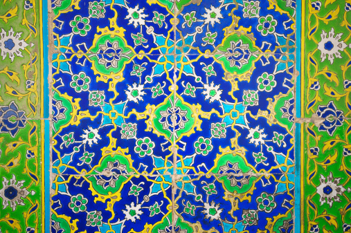 Medieval era glazed tile wall of intricate green and blue floral patterns in a Turkish Islamic mosque in Istanbul dating back to 1459