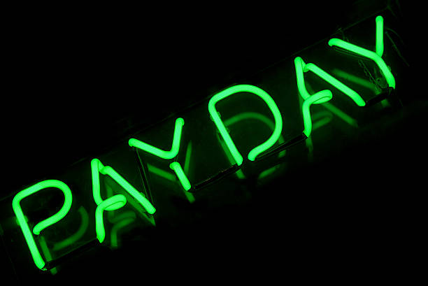 istock Pay Day Sign in Green Neon on Black 170160913