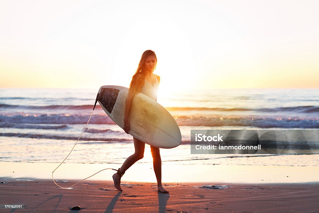 surfer girl surfer on the beach Beach Stock Photo