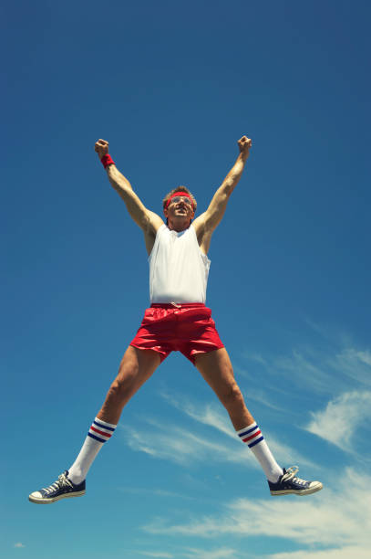 istock Nerd Athlete Does a Spreadeagle Jump in Blue Sky 170162029