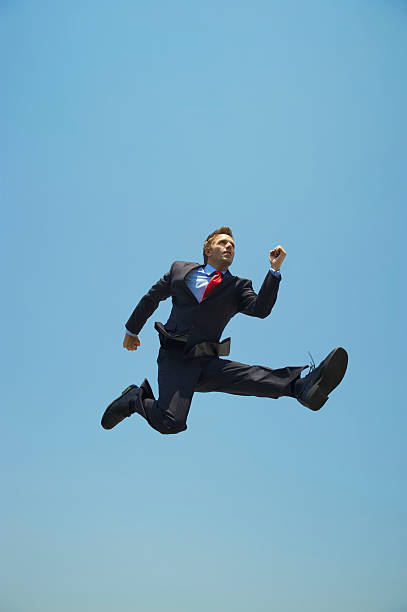 istock Young Businessman Jumping Outdoors High in Blue Sky 170162036