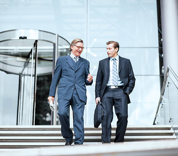 istock Two businesspeople going down the stairs. 170162185