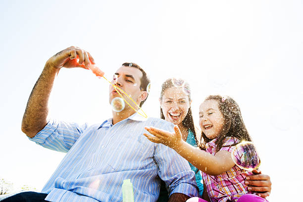 istock Cheerful family in park blowing bubbles. 170162230