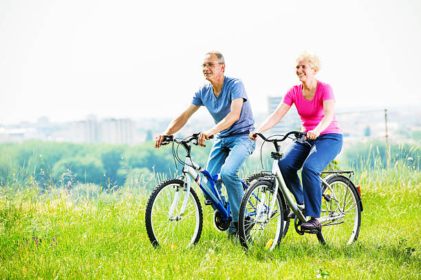 istock Cheerful mature couple riding bicycles in park. 170162295
