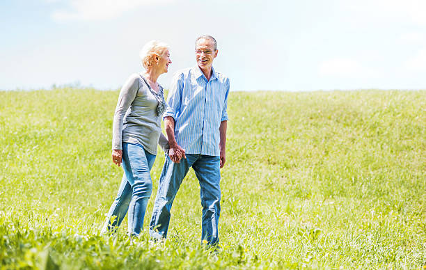 istock Happy mature couple walking in the field. 170162539