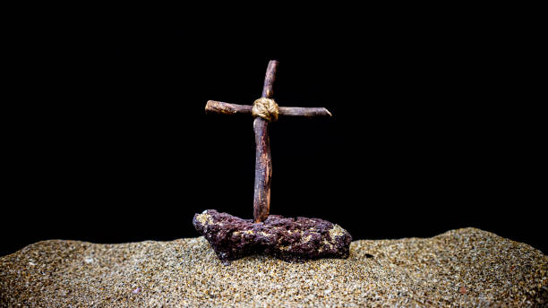 istock wooden cross on black background 1701629458