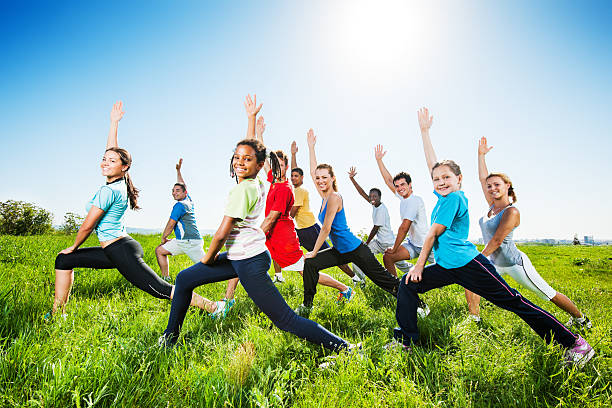 Large group of people exercising together in nature.    