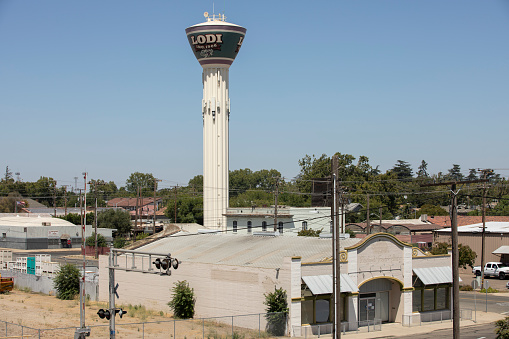 Lodi, California, USA - July 16, 2021: Afternoon sunlight shines on the iconic water tower in downtown Lodi.