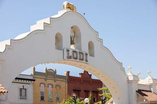 Lodi, California, USA - July 16, 2021: Afternoon sunlight shines on the historic bell arch way in downtown Lodi.