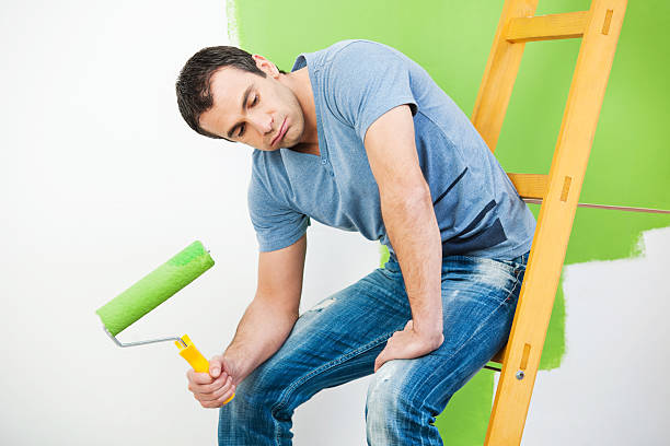 istock Tired man resting after painting the wall 170164570