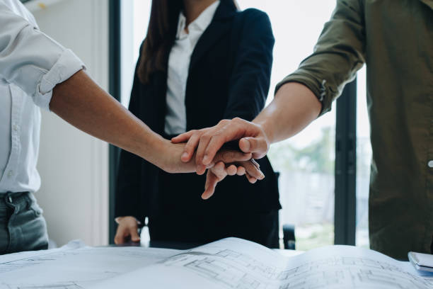 istock Engineers, designers and interior designers are together hands deal finalizing the design of interiors by discussing selecting materials and colors to design rooms to present to clients 1701646202