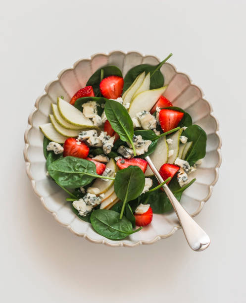 istock Pear, spinach, gorgonzola cheese, strawberry salad on a light background, top view 1701671479