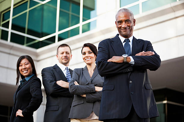 istock Businesspeople standing outside office building 170168712