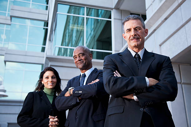 istock Businesspeople standing outside office building 170168719