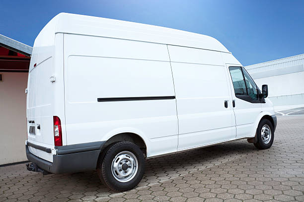 White Van on parking lot is waiting for next order side view of a white tranporter, isolated on white car transporter photos stock pictures, royalty-free photos & images