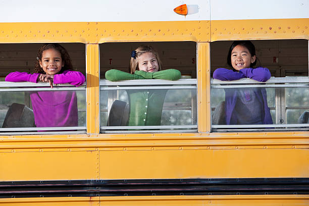 istock Children looking out school bus window 170169072
