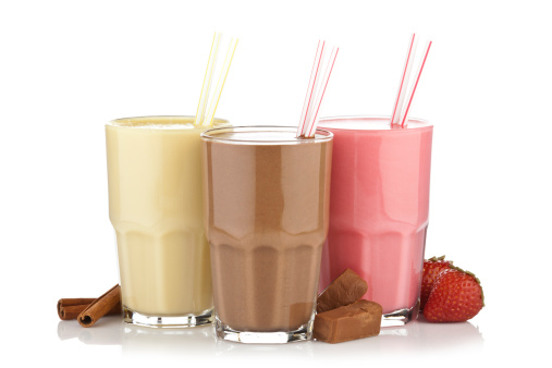 Smoothie Trio. Chocolate, Strawberry and Vanilla Milk Shake on Reflective White Background.