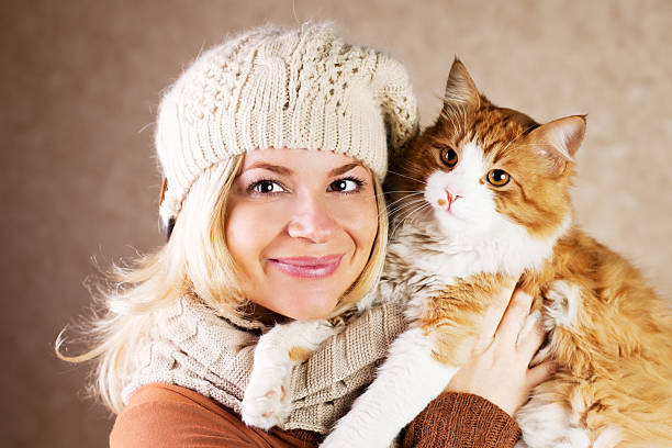 istock Smiling woman holding her cute cat 170169343