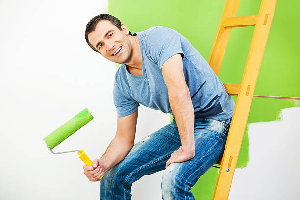 istock Young man decorating the house. 170169425