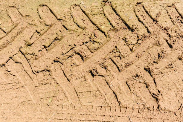 istock Tractor wheel tracks on wet mud. 1701708429