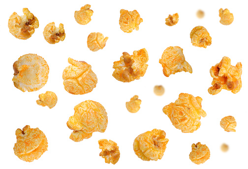Falling Delicious cheese popcorn isolated on white background. Popcorn with cheddar cheese flakes fall.