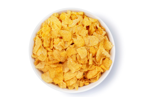 Overhead view of a bowl of corn flakes isolated on white.