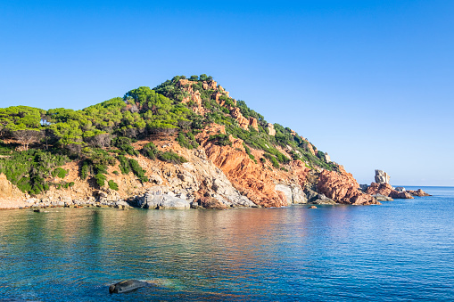 Cala Moresca of Arbatax, a bay protected by red porphyry cliffs covered by Mediterranean scrub