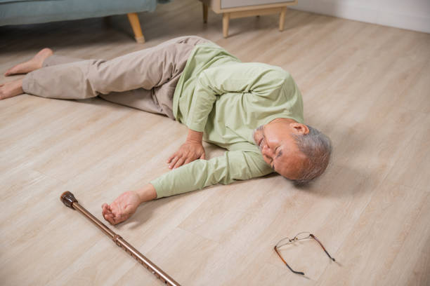 istock Older senior man headache lying on the floor after falling 1701726781