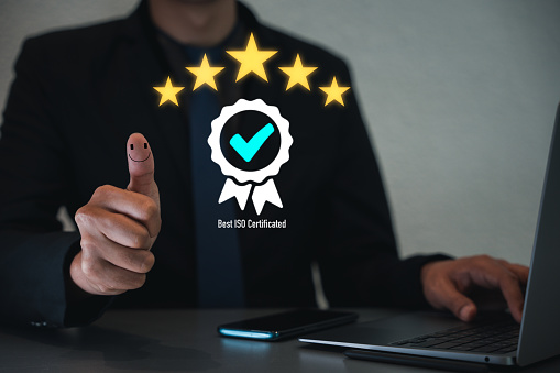 Assurance of top service in business, with ISO certification and compliance with regulations. Businessman giving thumbs up to show approval of service quality and customer satisfaction. Improvement