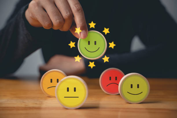 istock Selecting a smiley face on a wooden block circle 1701726811