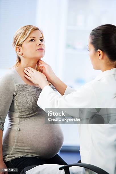 Female Doctor Examining Her Patient Stock Photo - Download Image Now - Pregnant, Doctor, Women
