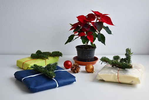 High angle of Christmas gifts with Christmas tree, wrapped paper and Christmas ornaments