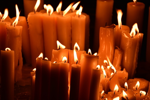 Closeup of candles burning in a church