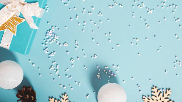 istock Christmas decoration. Gift boxes and Christmas decorations on pastel blue background, flat lay. Top view. Copy space 1701737268