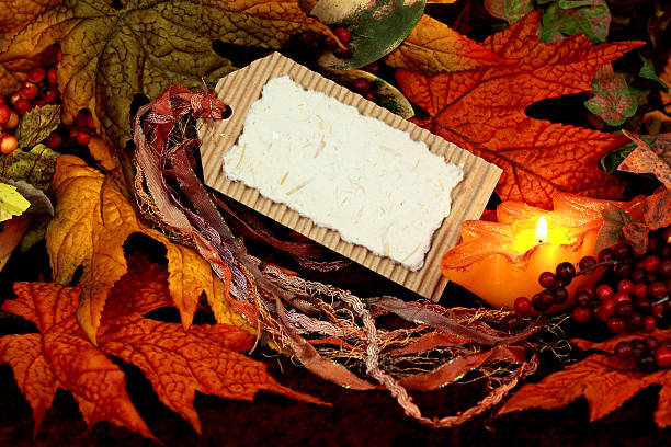 Blank Thanksgiving or autumn card with ribbon, autumn leaves, berries and candle