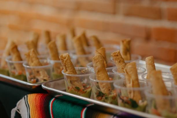 istock Rustic wooden table with a selection of containers filled with fresh guacamole 1701764202