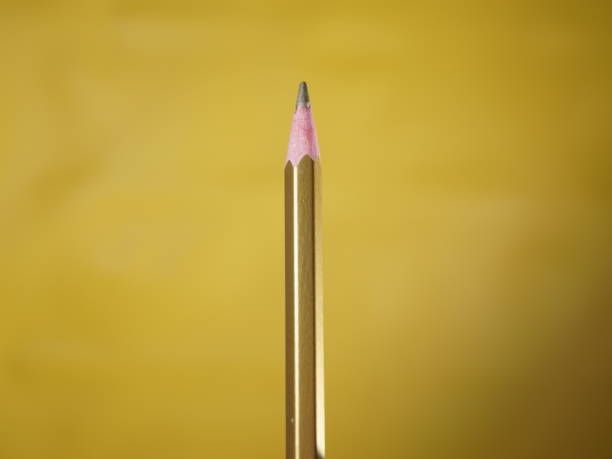istock colored pencils gold color on yellow background 1701774917