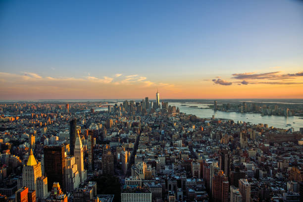 View of New York City Skyline from the Empire State Building at Dusk, with the One World Trade Center Building in the Background View from the top of the Empire State Building in Manhattan, New York City, featuring the Hudson River and the One World Trade Center. new york life building stock pictures, royalty-free photos & images