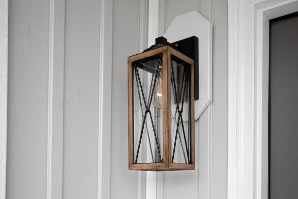 istock Southern Rustic Farmhouse Front Porch Light Sconce Next To Front Door and Grey Siding. Copyspace 1701776512