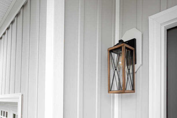 istock Southern Rustic Farmhouse Front Porch Light Sconce Next To Front Door and Grey Siding. Copyspace 1701777034