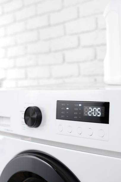 istock Modern white washing machine in a laundry room 1701782109