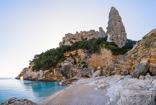 The pyramidal Guglia di Goloritzé watches over the Cala Goloritzé, a cove of white small pebbles lapped by crystal water (6 files stitched)