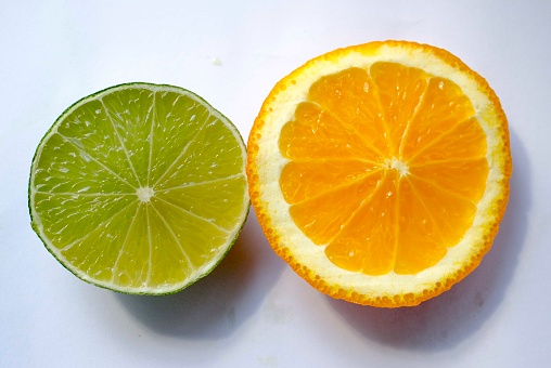 minneola, cut orange, cut lime fruit and cut passion fruit on a white background