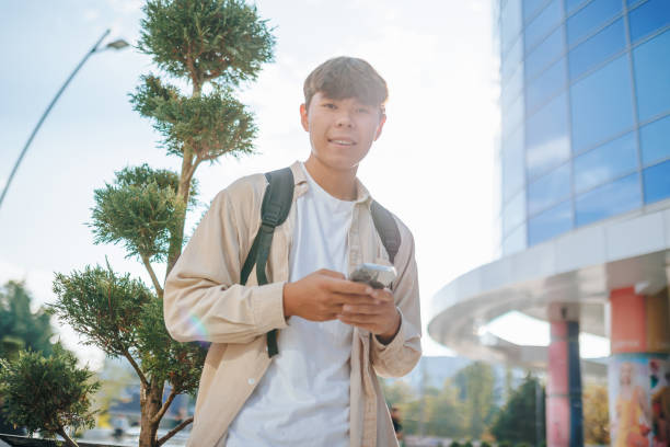istock Joyful Asian Student looking at camera Engaged in Online Chat 1701813910