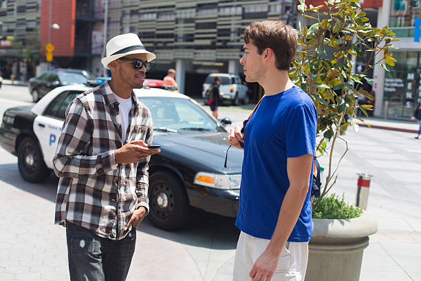 Young Men Texting on the Street